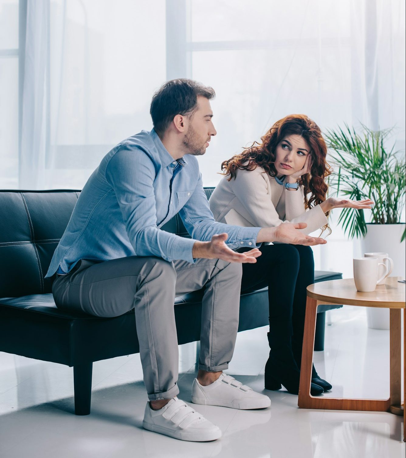 Divorcing young couple arguing in psychiatrist office